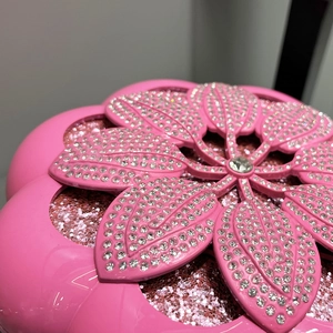 Macro shot of pink flower evening bag with intricate rhinestone floral petal details