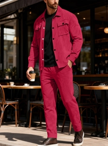 Detail view of premium red faux suede jacket and matching trousers for men in a street setting