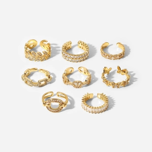 Set of 8 gold ear cuffs featuring leaf, butterfly, and cubic zirconia geometric designs