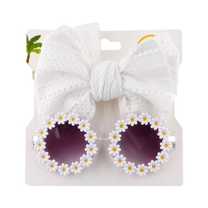Detail of baby daisy sunglasses with purple gradient lenses and white lace bow headband
