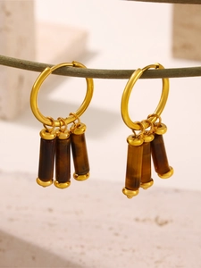 Detailed view of 18k gold plated stainless steel earrings with tiger eye stone drops