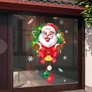 Detail of Christmas window sticker featuring Santa in a pine wreath with golden bells