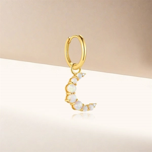 Gold moon drop earring detail with white opal stones and sparkling zircon accents
