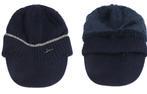 Detailed view of dark blue knit brimmed hat with thick warm fleece lining and metal logo