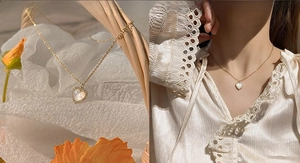 Detail view of gold heart necklace with white pearl shell inlay and model wearing shot