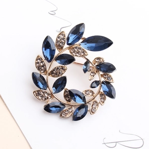 Floral enamel wreath brooch with deep blue marquise crystals and rhinestones in gold finish