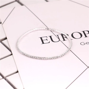 Detail view of a 2.0mm silver elastic tennis bracelet featuring sparkling clear crystals