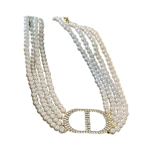 Elegant four-layer pearl necklace with a gold crystal-encrusted CD letter charm