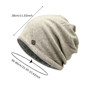 Oatmeal ribbed knit slouchy beanie with metal logo and size measurements 28x56-60cm