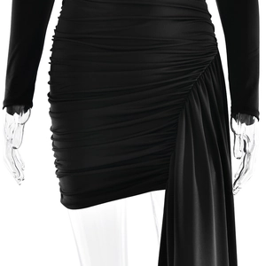 Detail of elegant black pleated long sleeve dress with side drape on mannequin
