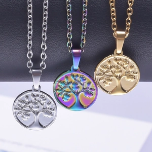Three tree of life necklaces in silver, gold, and multicolor on black display stand