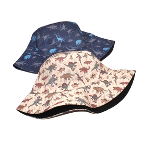 Reversible summer bucket hat with cartoon dinosaur prints in navy blue and beige colors