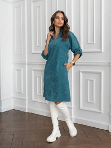 Detail of teal corduroy midi dress showing V-neck design and soft ribbed fabric texture