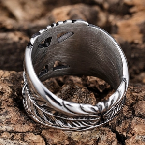 Vintage stainless steel wide feather ring with triangle cutout design on tree bark background