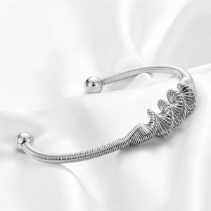 Silver stainless steel spiral cuff bracelet with 18K gold finish and sphere ends