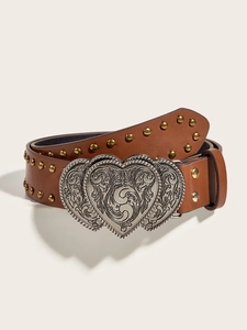 Close-up of brown leather belt featuring an ornate silver heart buckle and vintage studs