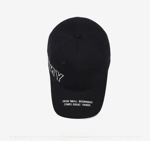Detail of embroidered 'MY' letters and motivational phrase on black cotton baseball cap