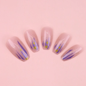 Detailed view of pink press-on nails with purple geometric lines and gold glitter stars