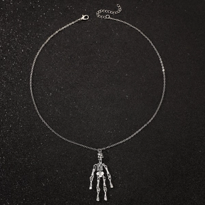 Punk style silver skull pendant necklace with detailed joints on a dark textured background