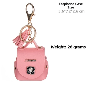 Detailed view of pink faux leather earphone pouch with camellia charm and metal keychain