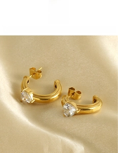 Detailed macro view of 18k gold plated titanium steel C-shape earrings with zircon
