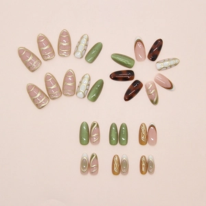 Detailed flat lay of emerald cat-eye and tortoiseshell press-on nails in almond shape