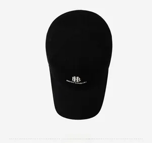 Top view of a black baseball cap with silver embroidery and breathable eyelets