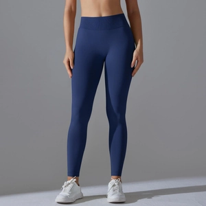 Detail of high-waist seamless knit yoga leggings in deep blue with tummy control waistband