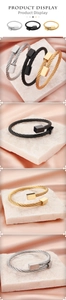 Detailed view of twisted steel cable bangles in silver, black and gold with square tips