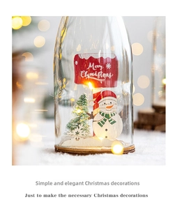 Close-up of a lit Christmas glass dome with a snowman and warm LED string lights inside