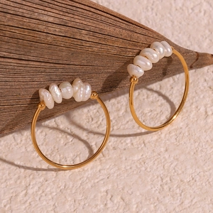 Close-up of gold 18K plated stainless steel earrings with irregular freshwater pearls