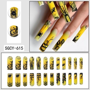 Halloween press-on nails with yellow and black gradient featuring spider and pumpkin art