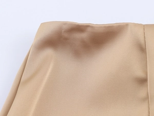 Close-up of khaki twill fabric texture and professional stitching on partywear set