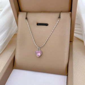 Detailed close-up of a heart-shaped pink zircon pendant on a silver steel chain