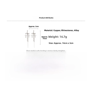 Detail view of cross tassel earrings with rhinestones showing 14cm length and 3cm width