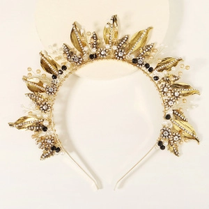 Detail of gold leaf crown with clear crystals and white pearls for wedding parties