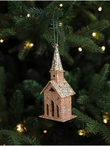 Close-up of glitter champagne gold church pendant hanging on a Christmas tree