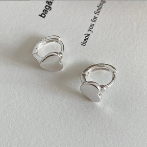 Minimalist 925 sterling silver heart-shaped hoop earrings on a textured display card