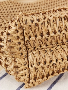Detailed close-up of handmade straw woven shoulder bag showing natural paper rope texture