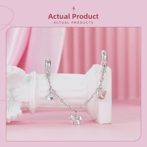 Detail of s925 silver safety chain with blue heart and purple butterfly charms
