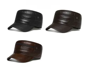 Detail view of leather flat top military caps in black and brown with metal zipper decor