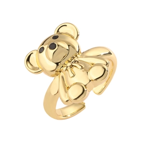 Adjustable gold bear ring with black eyes and bow detail on a white background