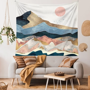 Detailed close-up of mountain landscape tapestry hung above a sofa for wall decor