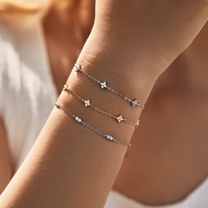 Elegant s925 silver and gold clover bracelets with diamonds on a model's wrist