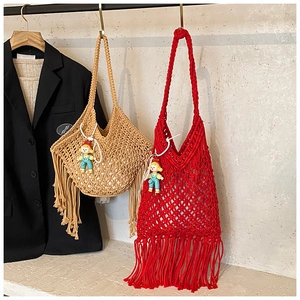 Detail of handmade woven net tote bags with long tassels in khaki and red colors