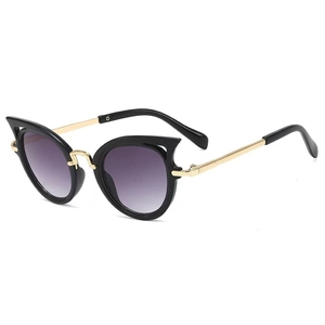 Fashionable cat-eye kids sunglasses with black frames, gold metal temples, and purple lenses