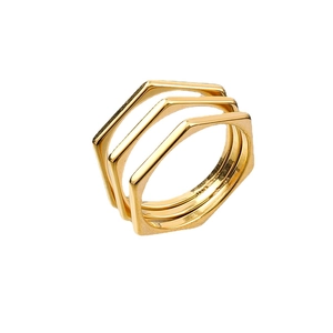 Three-piece set of minimalist hexagon stackable rings in polished gold-plated titanium steel