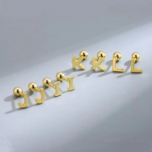 Detail of gold letter earrings J, K, and L with secure screw-back ball closures
