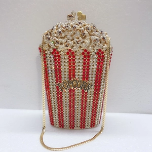 Detailed close-up of a popcorn-shaped evening bag with red and white sparkling rhinestones