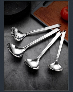 Macro detail of high-quality 304 stainless steel soup ladles and colander on a grey countertop